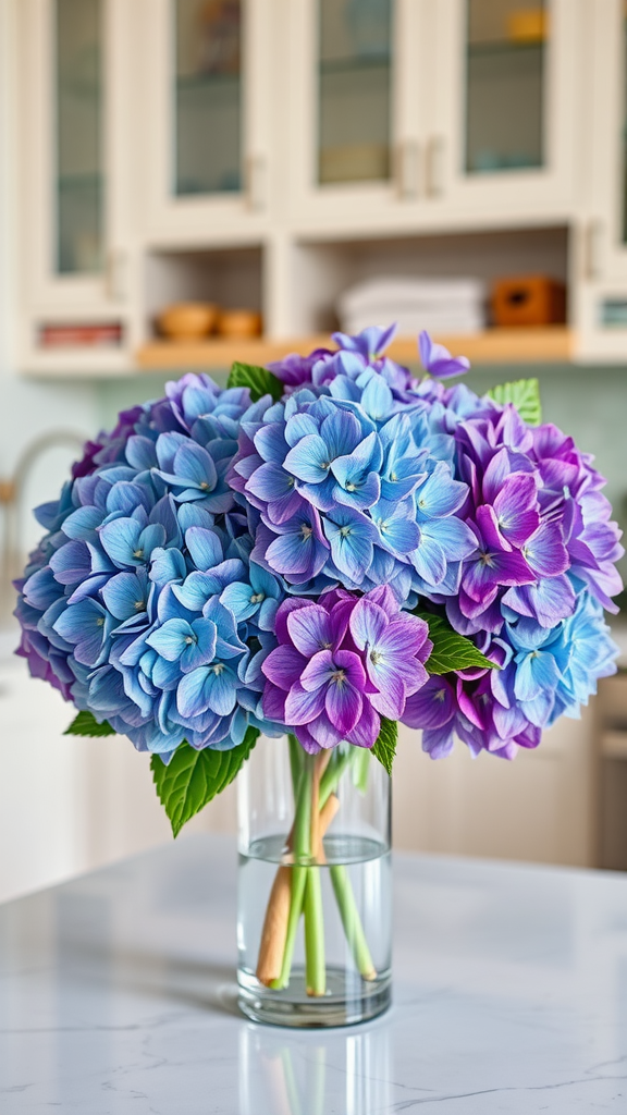 20 Stunning Hydrangea Bouquets for Every Occasion A bouquet of blue and purple hydrangeas in a clear vase on a kitchen counter.