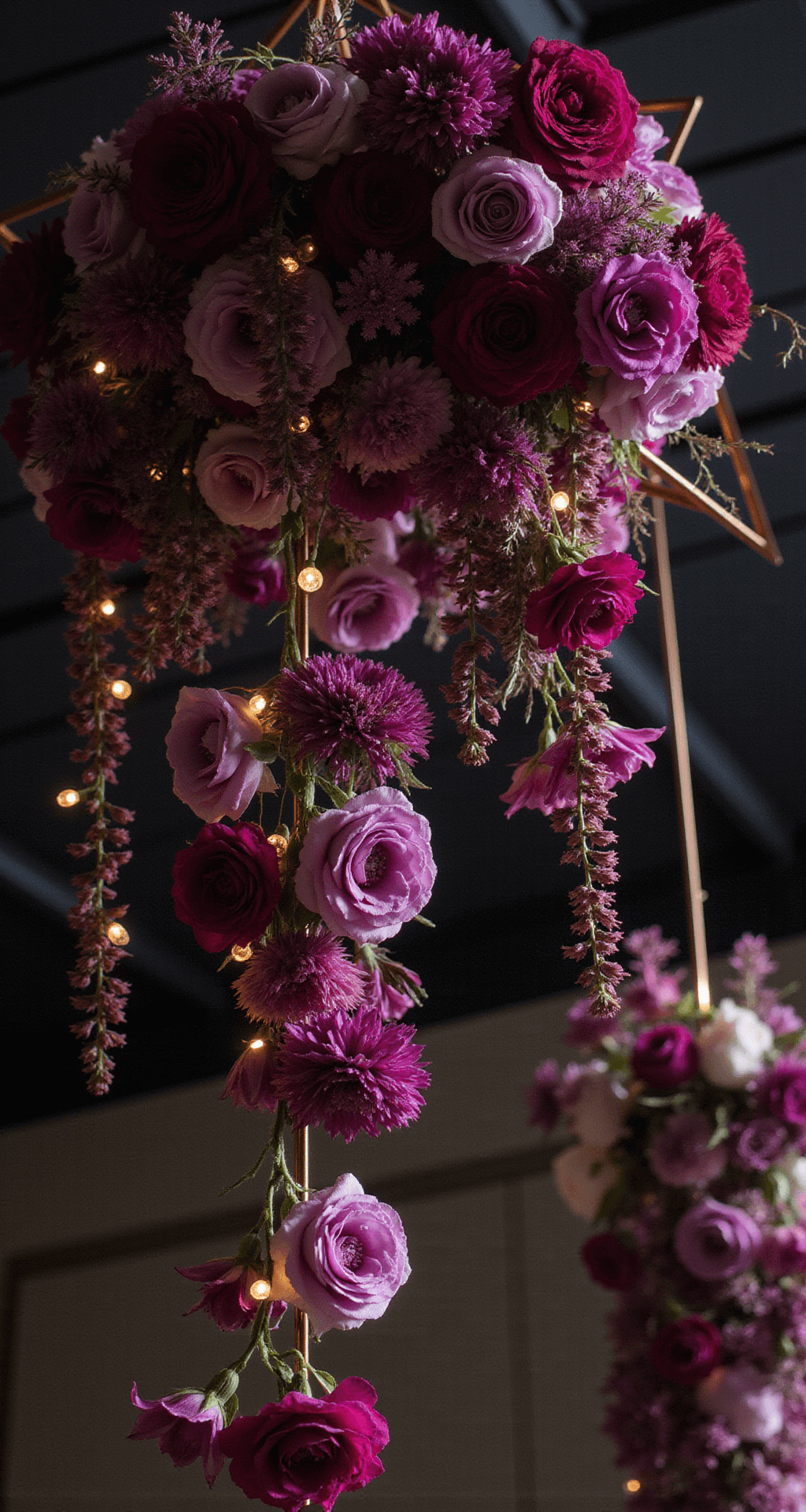 The Ultimate Guide to Vibrant Wedding Flowers: Creating Unforgettable Floral Magic A dramatic close-up of a suspended floral installation featuring deep magenta and purple blooms cascading from copper geometric frames, with smooth calla lilies and ruffled garden roses, twinkling fairy lights in between, captured from below against a dark ceiling.