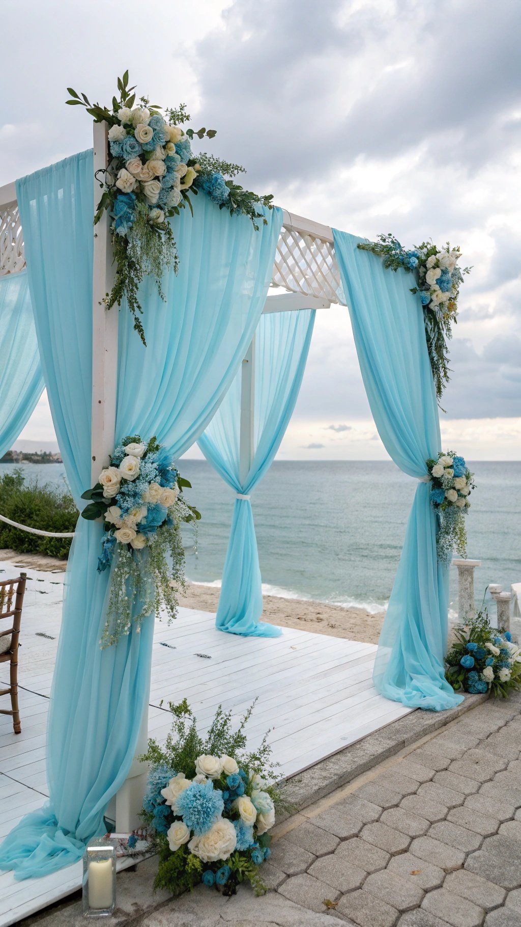 16 Stunning Baby Blue Wedding Ideas for Your Dream Day A serene baby blue wedding ceremony backdrop with draped fabric and floral arrangements by the beach.
